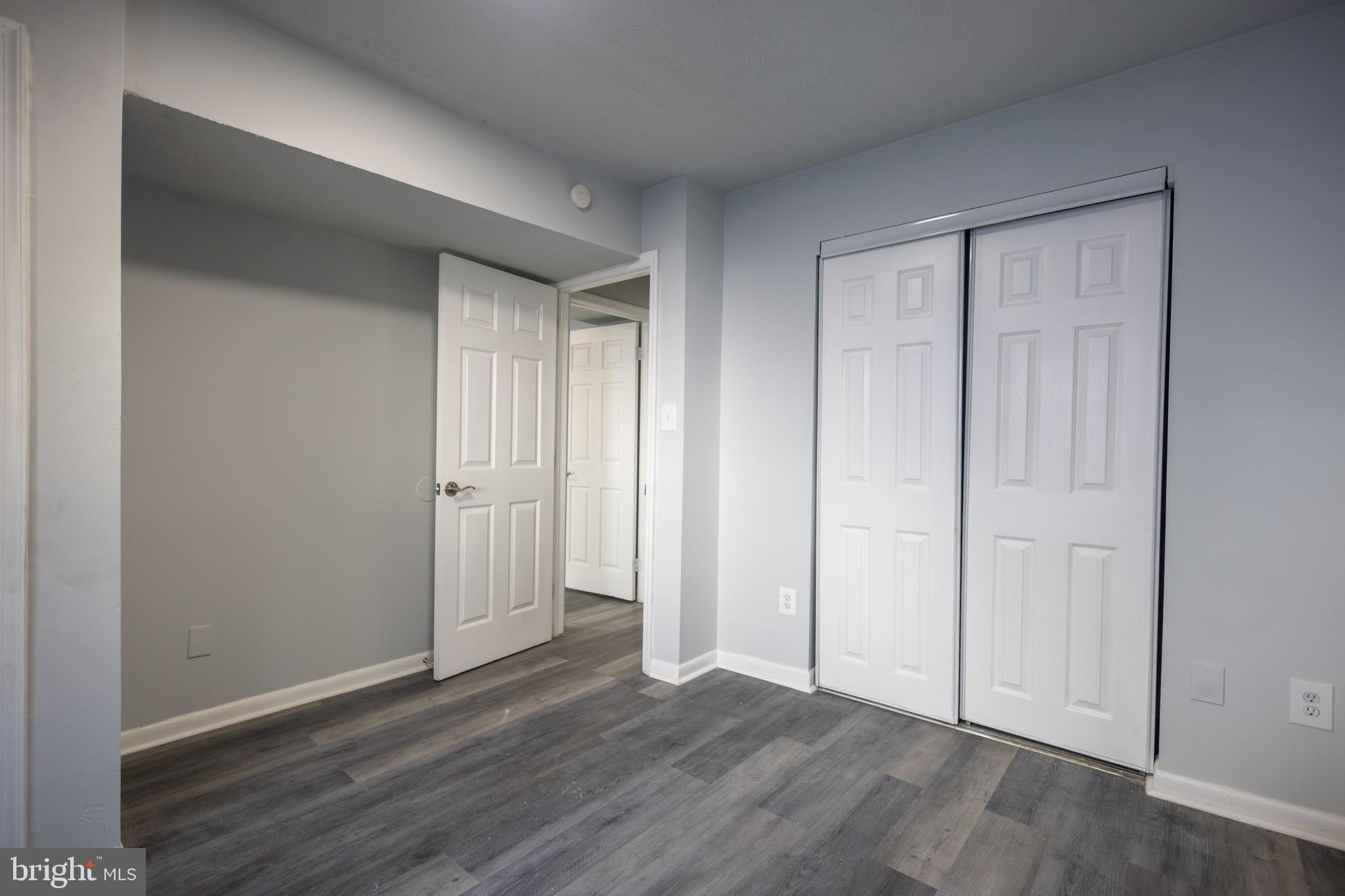 1300-1302 Morris Road Southeast, Unit A6 Washington, DC 20020 - Photo 2 of 13 a view of an empty room and wooden floor & closet area