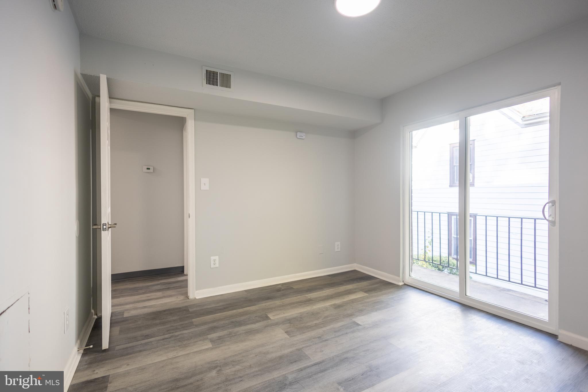 1300-1302 Morris Road Southeast, Unit A6 Washington, DC 20020 - Photo 4 of 13 a view of an empty room with wooden floor and a window