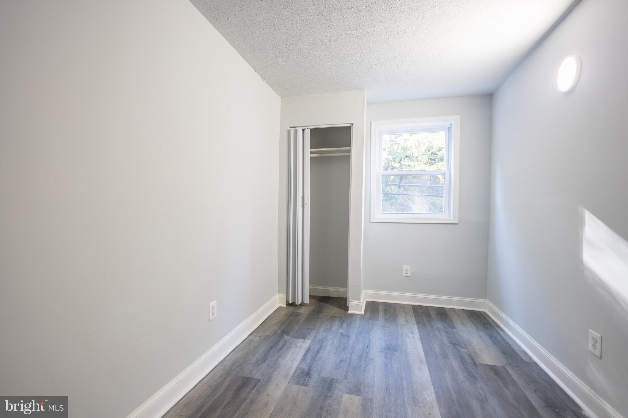 1300-1302 Morris Road Southeast, Unit A6 Washington, DC 20020 - Photo 7 of 13 an empty room with wooden floor and windows