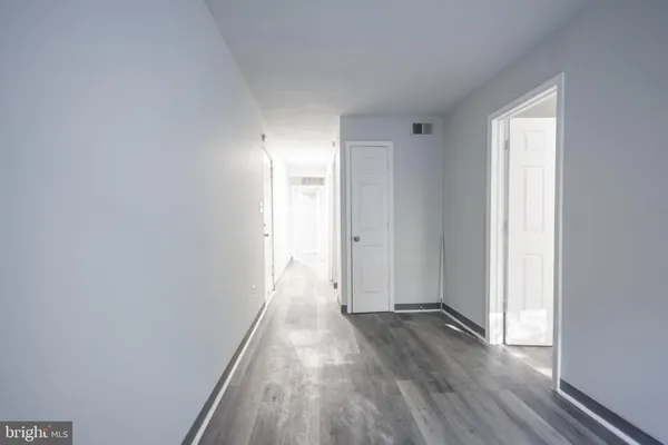 a view of hallway with wooden floor