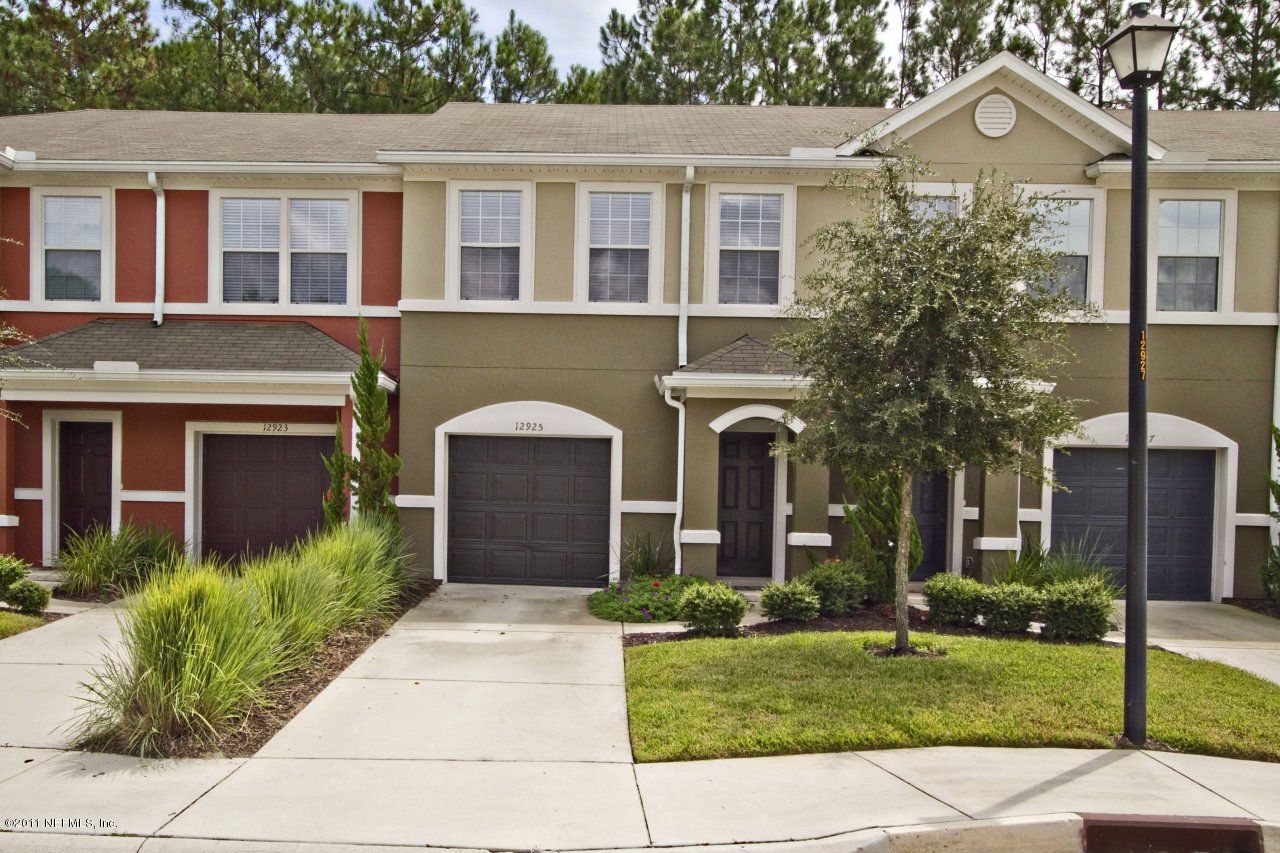 12925 Spring Rain Road Jacksonville, FL 32258 - Photo 1 of 17 a front view of a house with a yard