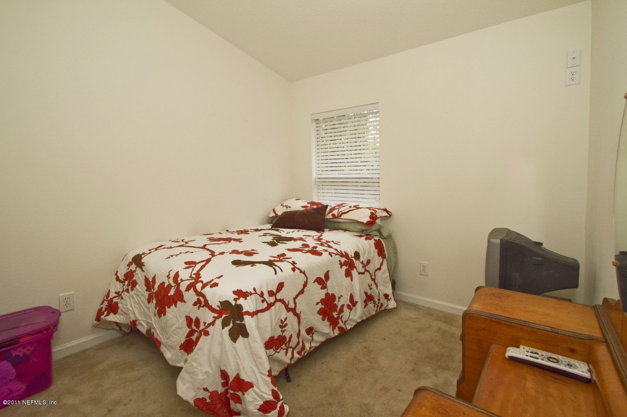 12925 Spring Rain Road Jacksonville, FL 32258 - Photo 11 of 17 a bedroom with a bed and a couch