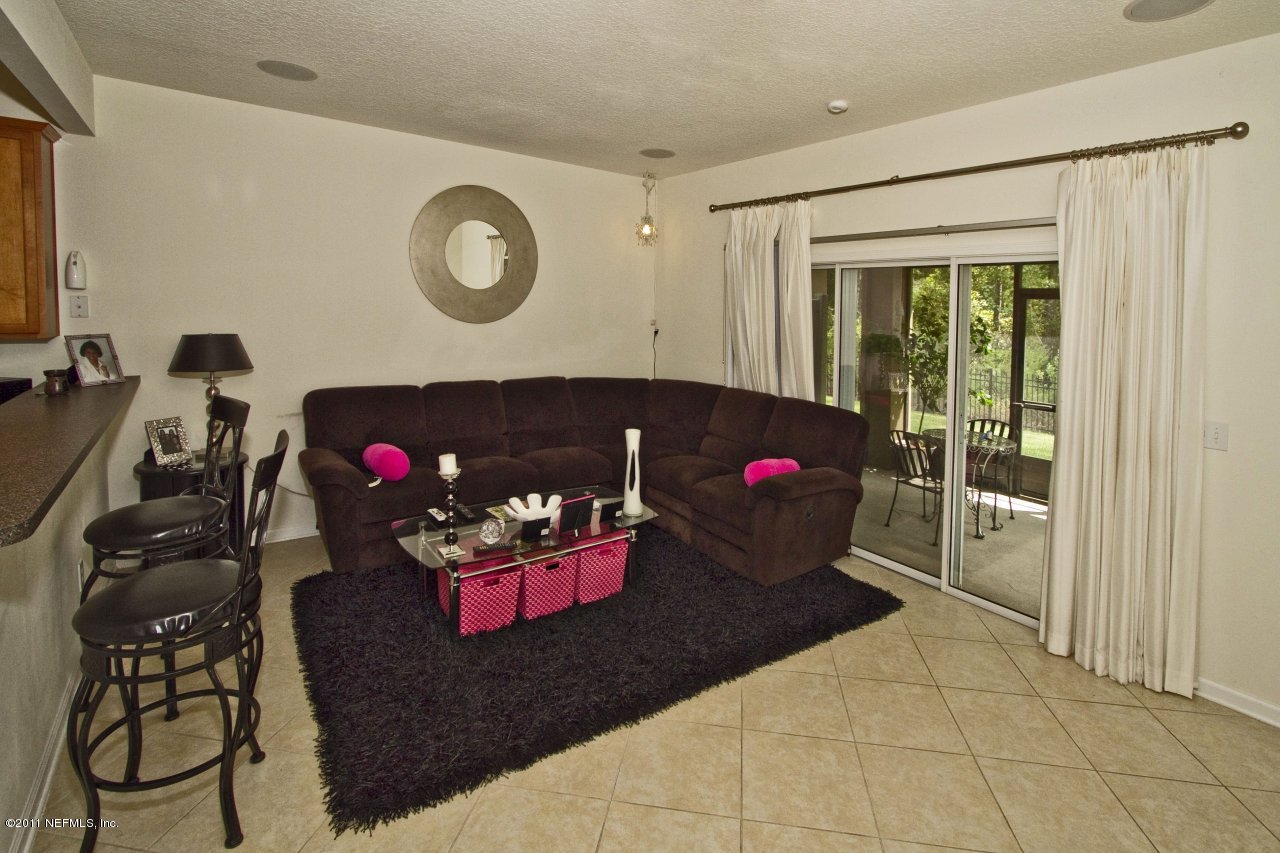 12925 Spring Rain Road Jacksonville, FL 32258 - Photo 4 of 17 a living room with furniture and rug