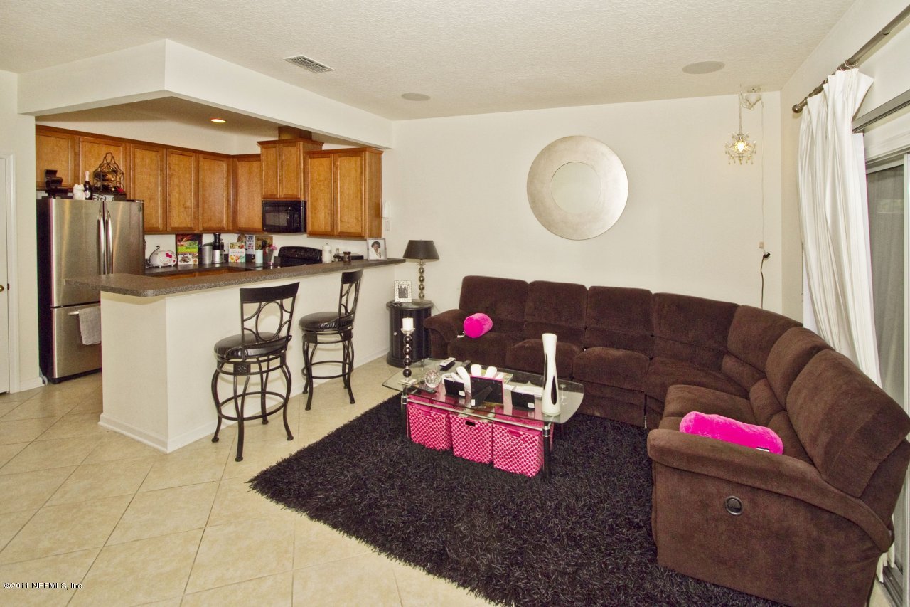 12925 Spring Rain Road Jacksonville, FL 32258 - Photo 5 of 17 a living room with furniture and a mirror