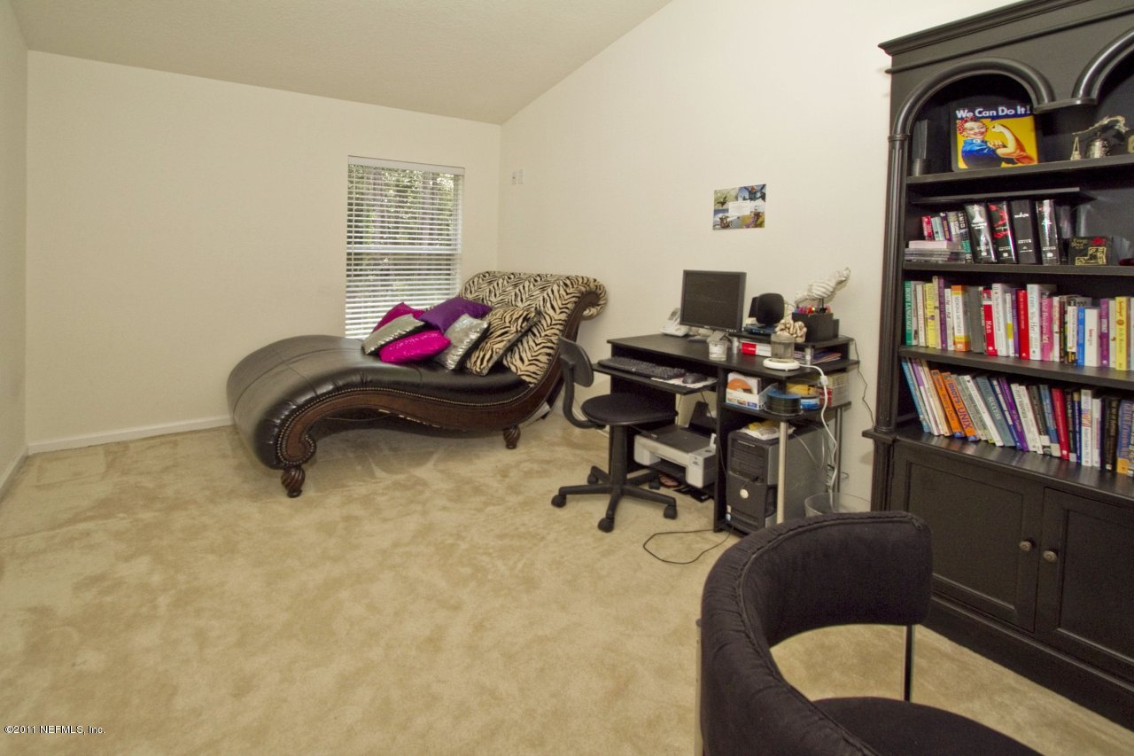 12925 Spring Rain Road Jacksonville, FL 32258 - Photo 8 of 17 a living room with furniture and a book shelf