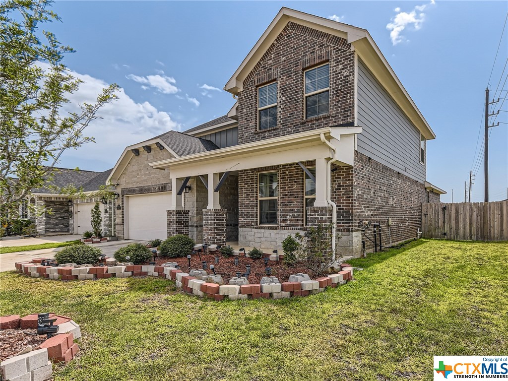 a front view of house with yard and outdoor seating