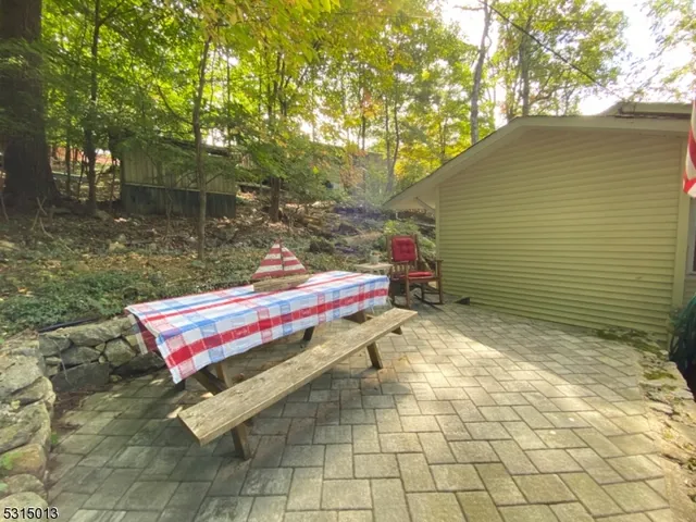 a backyard of a house with table and chairs
