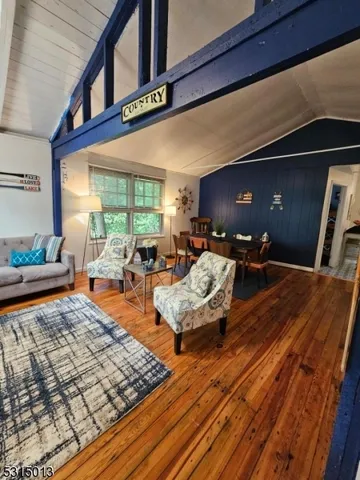 a living room with furniture rug and wooden floor