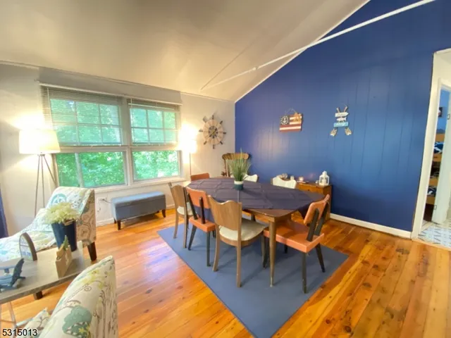 a dining room with furniture and wooden floor