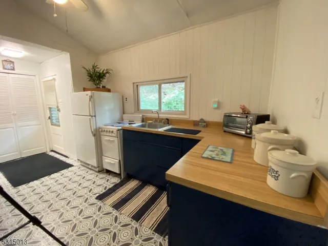 a room with a sink a table and chairs