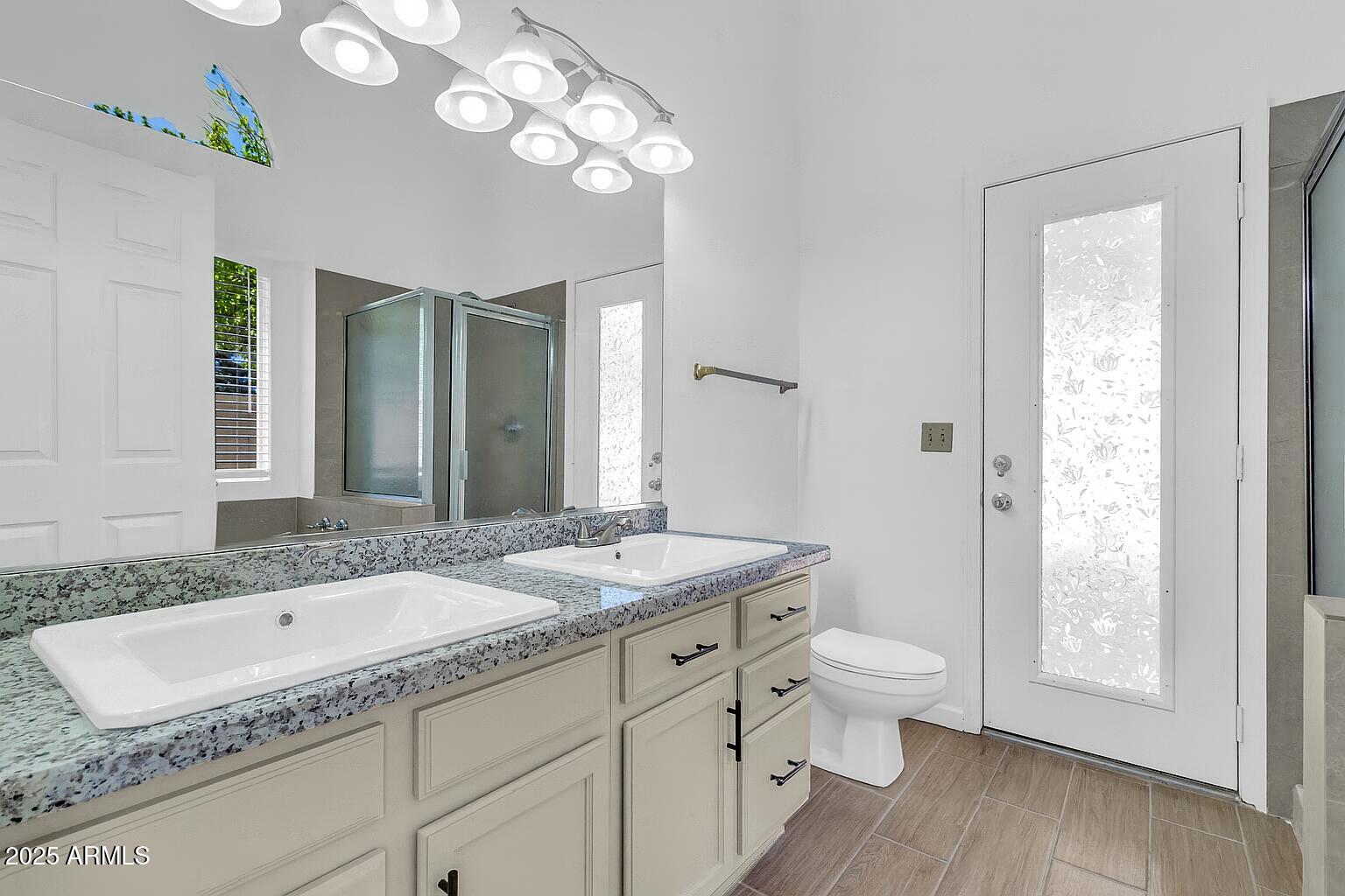 1511 West Wildhorse Court Chandler, AZ 85286 - Photo 20 of 31 a bathroom with a granite countertop sink and a mirror