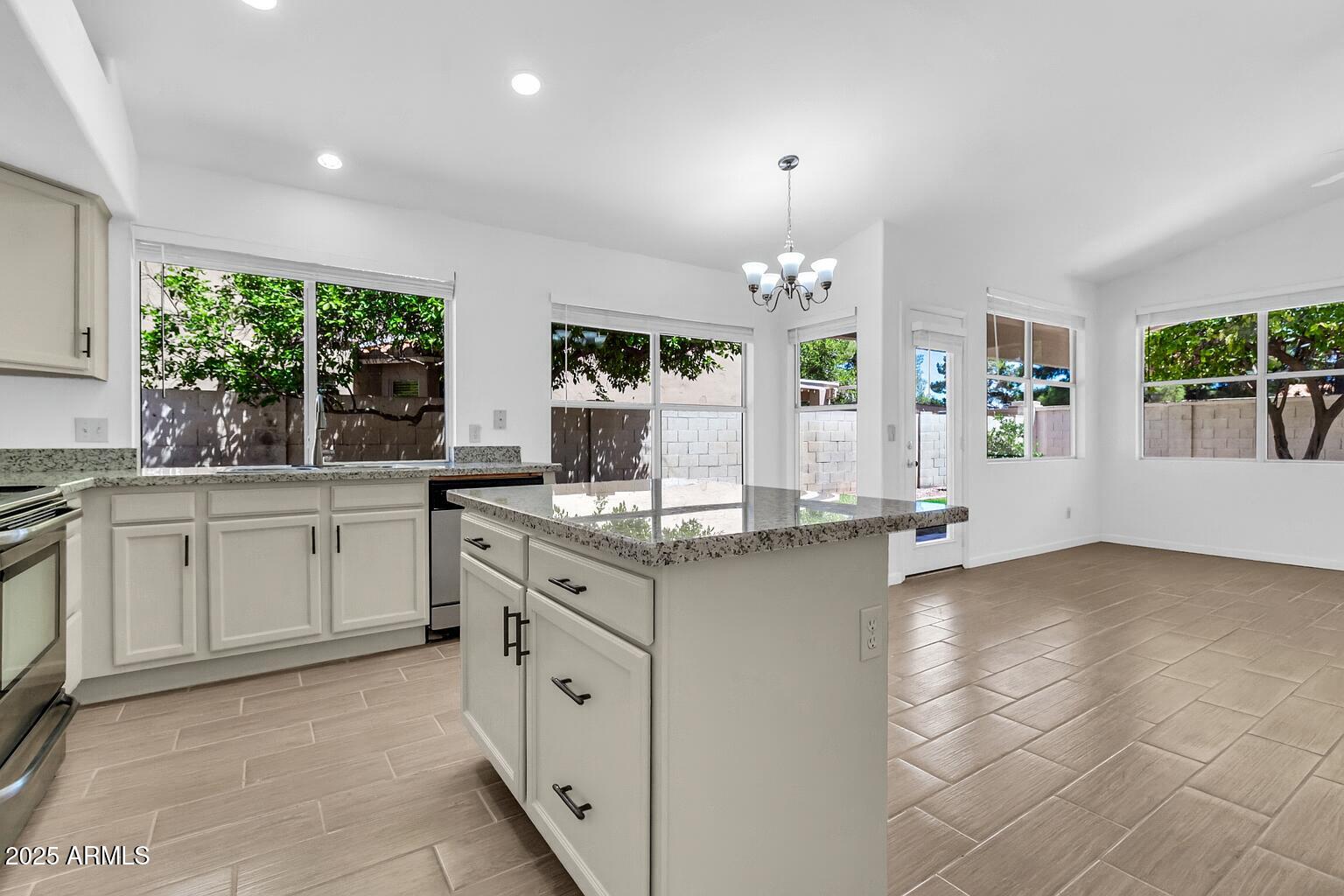 1511 West Wildhorse Court Chandler, AZ 85286 - Photo 6 of 31 a kitchen with granite countertop a sink cabinets and window