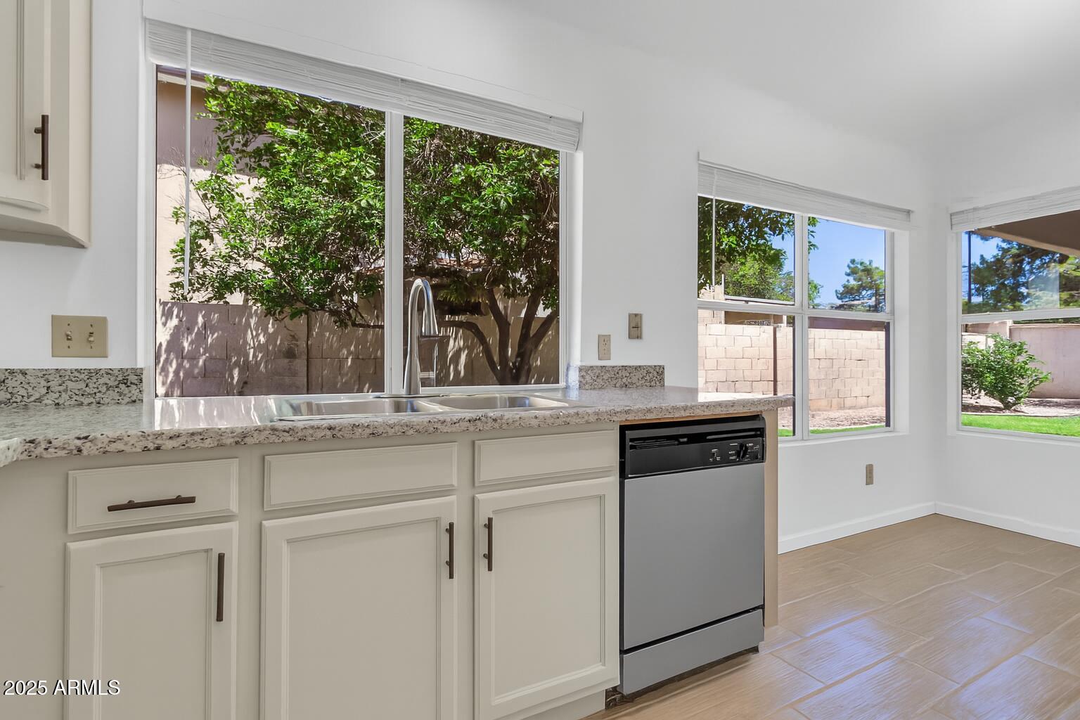 1511 West Wildhorse Court Chandler, AZ 85286 - Photo 7 of 31 a kitchen with granite countertop white cabinets and a window