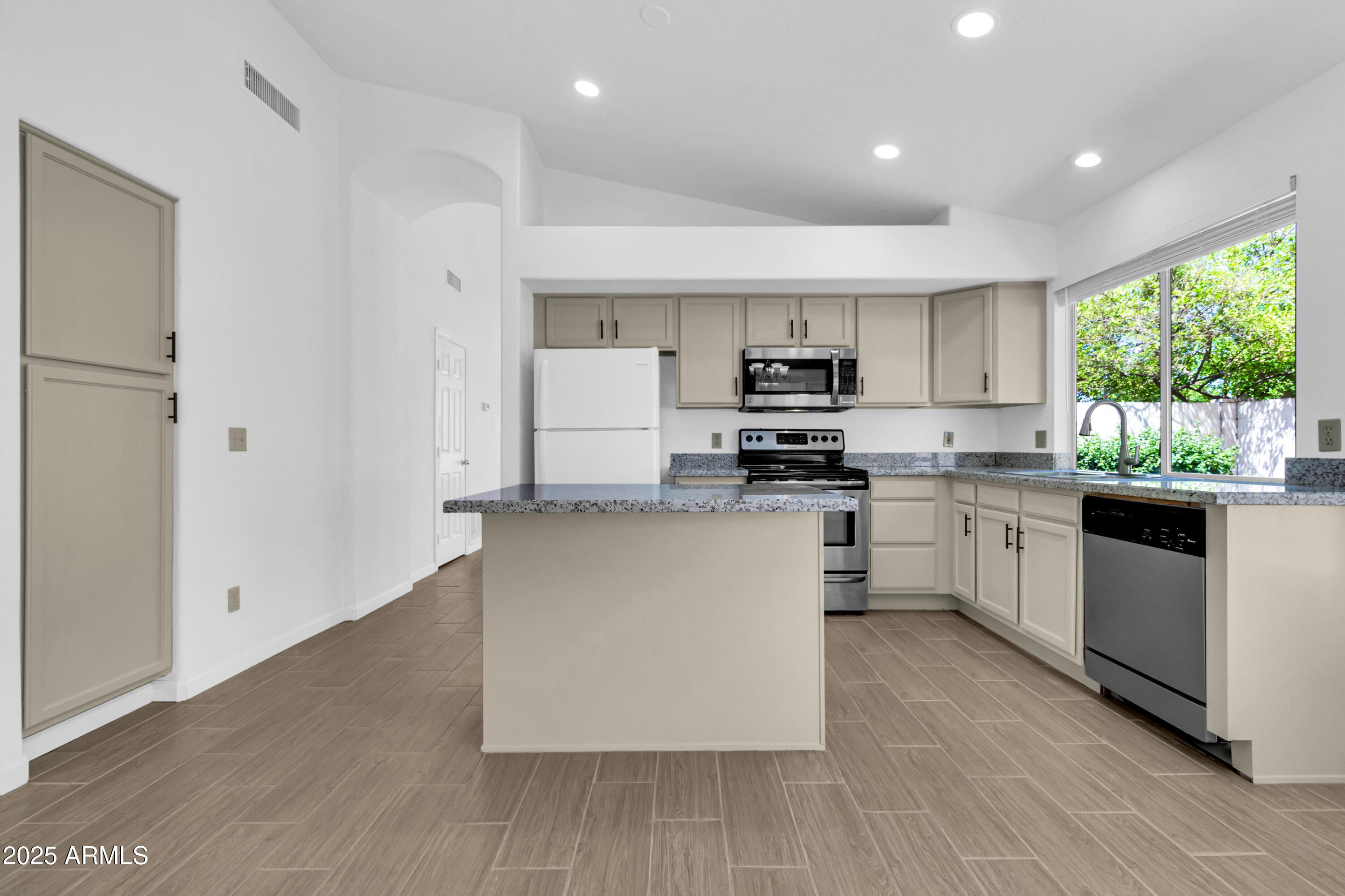 1511 West Wildhorse Court Chandler, AZ 85286 - Photo 8 of 31 a kitchen with white cabinets and white appliances