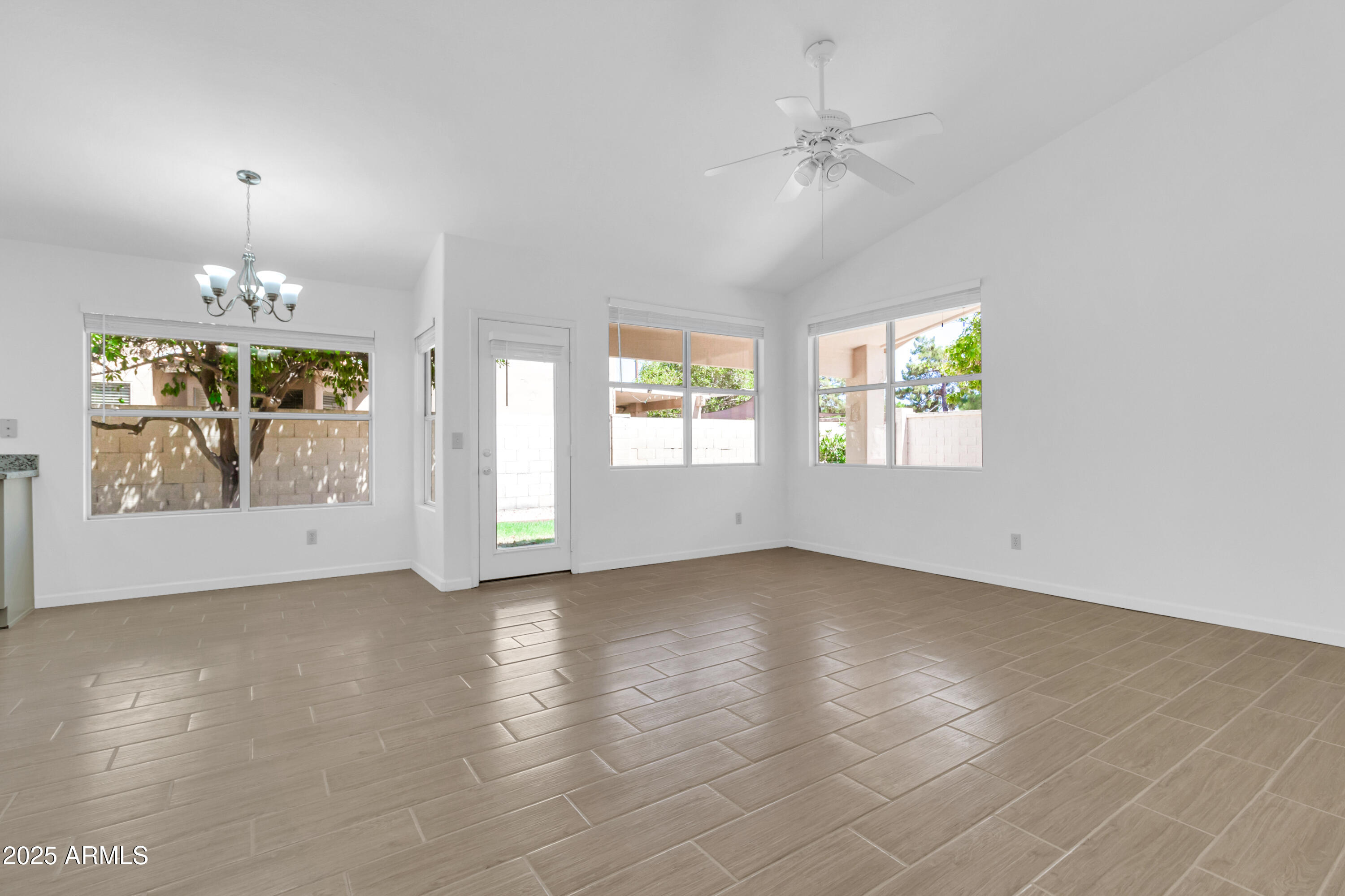 1511 West Wildhorse Court Chandler, AZ 85286 - Photo 9 of 31 an empty room with windows and chandelier fan