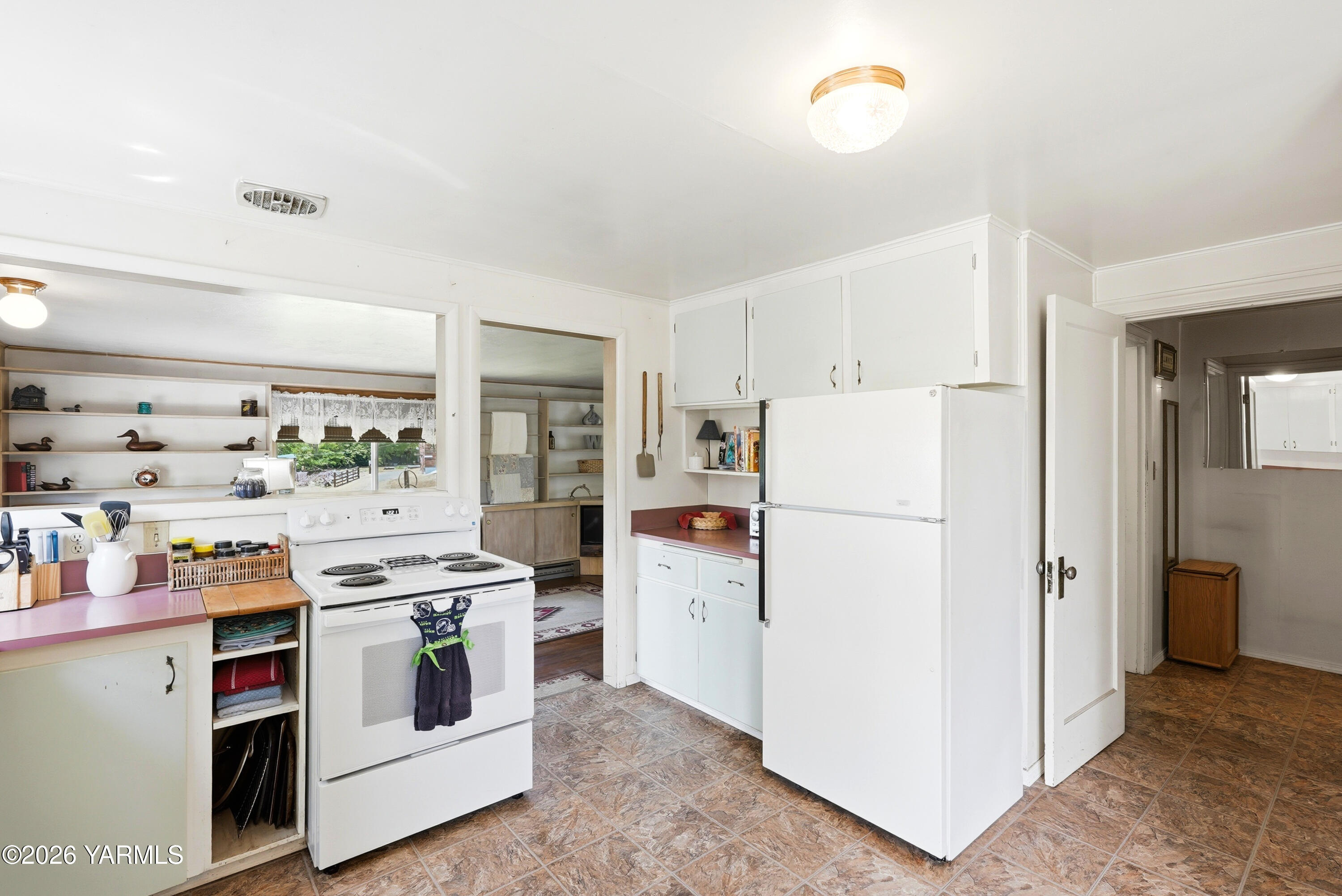 690 North Gleed Road Naches, WA 98937 - Photo 11 of 60 a white refrigerator freezer and a stove sitting inside of a kitchen