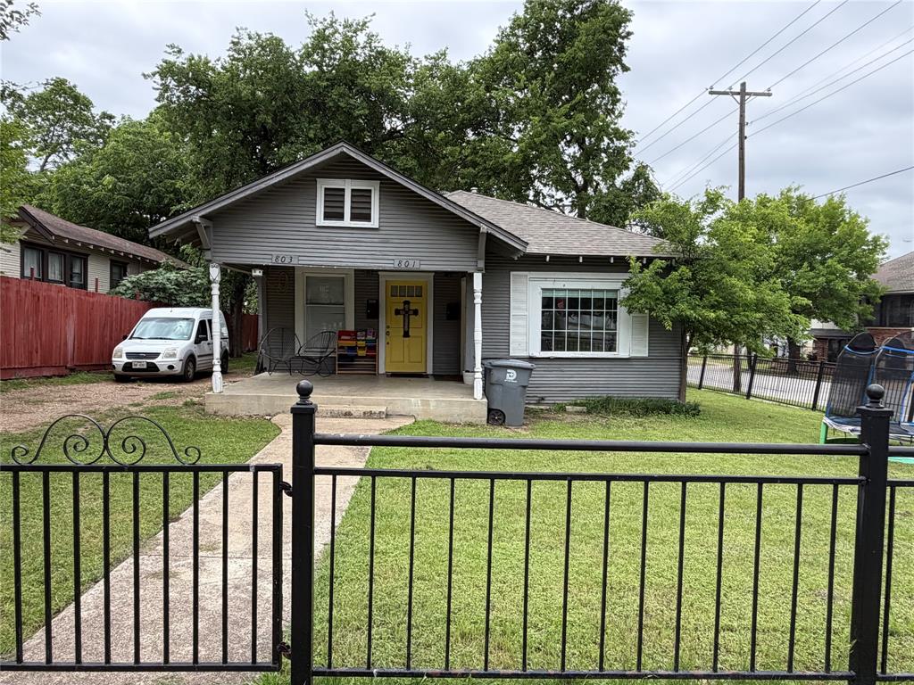 801 Wayne Street Dallas, TX 75223 - Photo 1 of 15 a front view of a house with a yard table and chairs