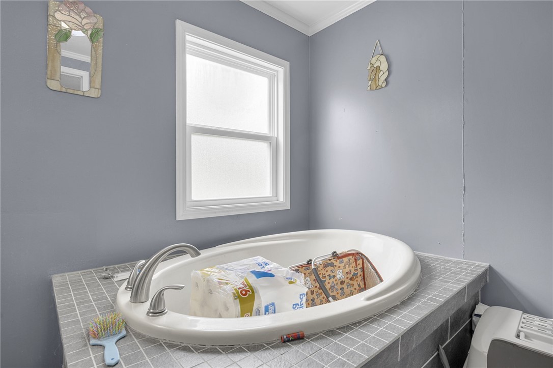 1549 Bethany Church Road Belton, SC 29627 - Photo 20 of 36 A spacious tub awaits, nestled below a well-placed window, offering a serene bathing experience.