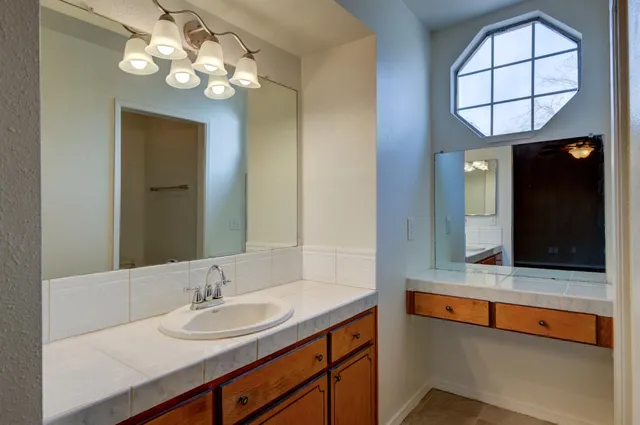 a bathroom with a sink and a mirror