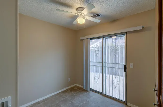 a view of a livingroom with a ceiling fan and window