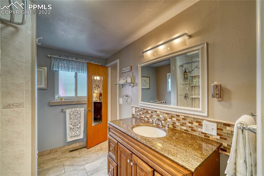 7035 Chippewa Road Colorado Springs, CO 80915 - Photo 11 of 22 a bathroom with a sink and a mirror