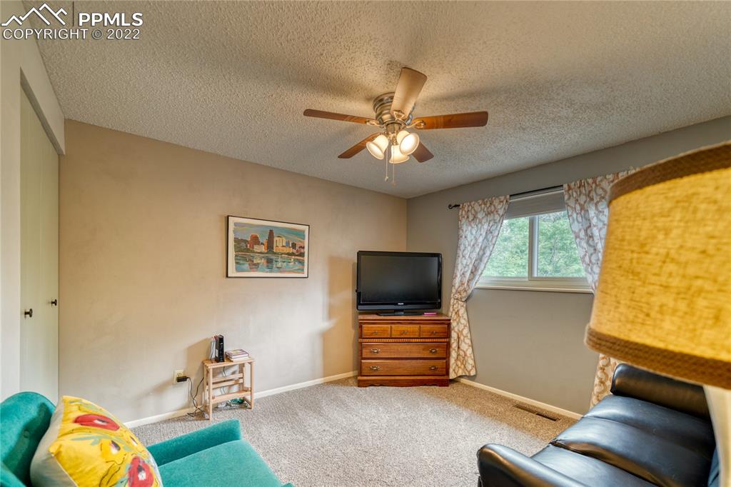 7035 Chippewa Road Colorado Springs, CO 80915 - Photo 13 of 22 a living room with furniture and a flat screen tv