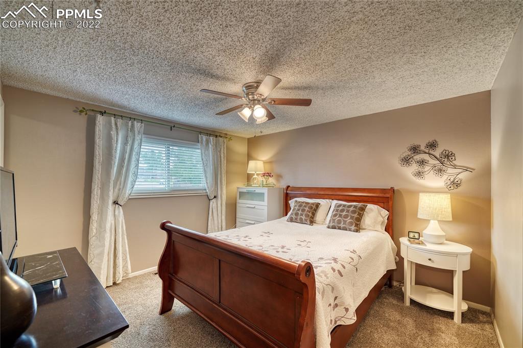 7035 Chippewa Road Colorado Springs, CO 80915 - Photo 15 of 22 a bedroom with a bed and window
