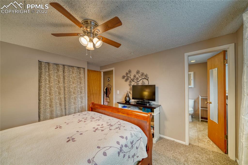 7035 Chippewa Road Colorado Springs, CO 80915 - Photo 16 of 22 a bedroom with a bed and a flat screen tv