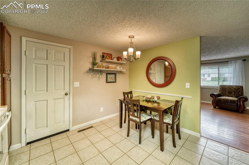 7035 Chippewa Road Colorado Springs, CO 80915 - Photo 17 of 22 a view of a dining room with furniture and a mirror