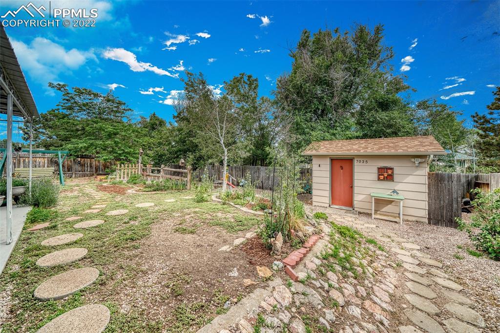 7035 Chippewa Road Colorado Springs, CO 80915 - Photo 8 of 22 a backyard of a house with table and chairs