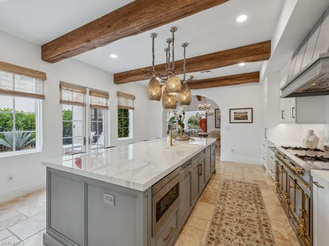 a kitchen with stainless steel appliances granite countertop a sink and stove