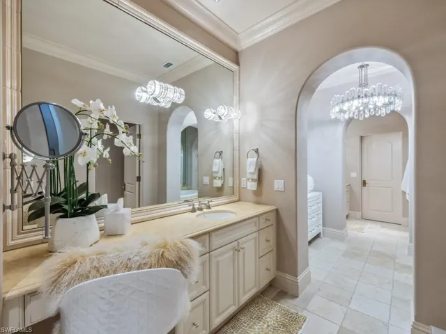a spacious bathroom with a granite countertop sink a large mirror and a shower