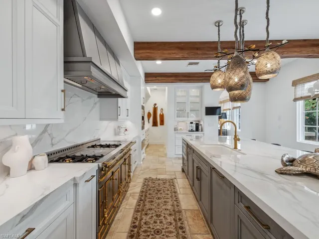 a kitchen with granite countertop a stove and cabinets