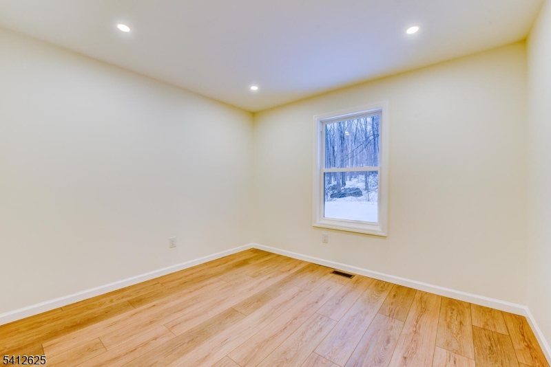 39 Old Road Ringwood, NJ 07456 - Photo 25 of 43 a view of empty room with wooden floor and fan