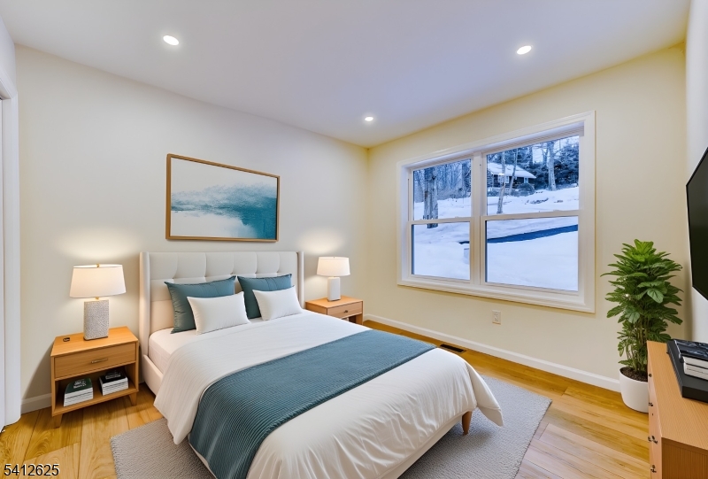 39 Old Road Ringwood, NJ 07456 - Photo 27 of 43 a bedroom with a large bed and a painting on the wall