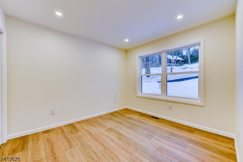 39 Old Road Ringwood, NJ 07456 - Photo 28 of 43 a view of empty room with wooden floor and fan
