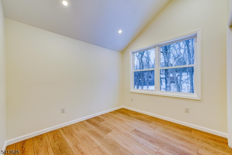 39 Old Road Ringwood, NJ 07456 - Photo 30 of 43 a view of an empty room with wooden floor and a window
