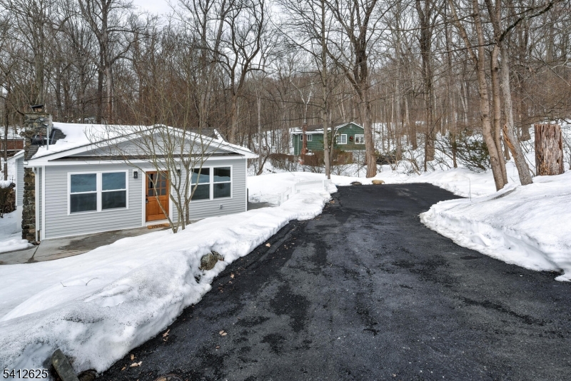 39 Old Road Ringwood, NJ 07456 - Photo 3 of 43 a front view of a house with a yard covered with snow