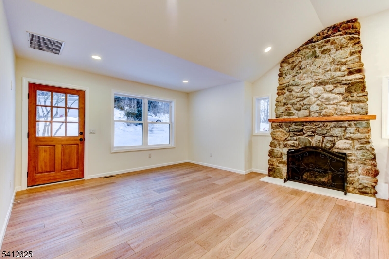 39 Old Road Ringwood, NJ 07456 - Photo 6 of 43 an empty room with windows and fireplace