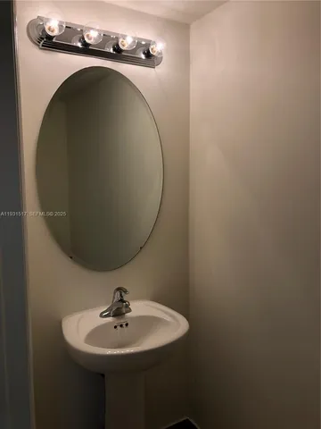 a bathroom with a sink and mirror