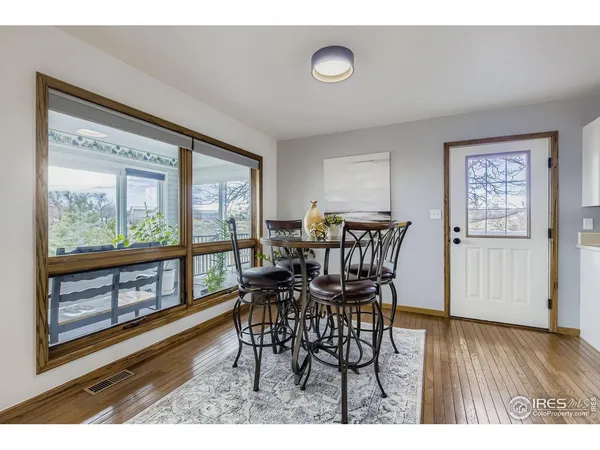 a view of a dining room with furniture window and wooden floor