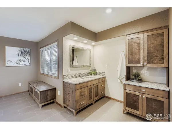 a living room with stainless steel appliances kitchen island granite countertop a stove and a cabinet