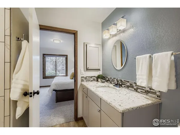 a en suite bathroom with a sink double vanity and a mirror