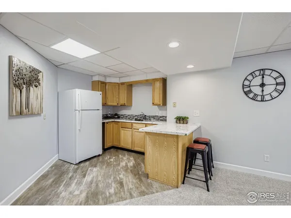 a kitchen with refrigerator cabinets and wooden floor