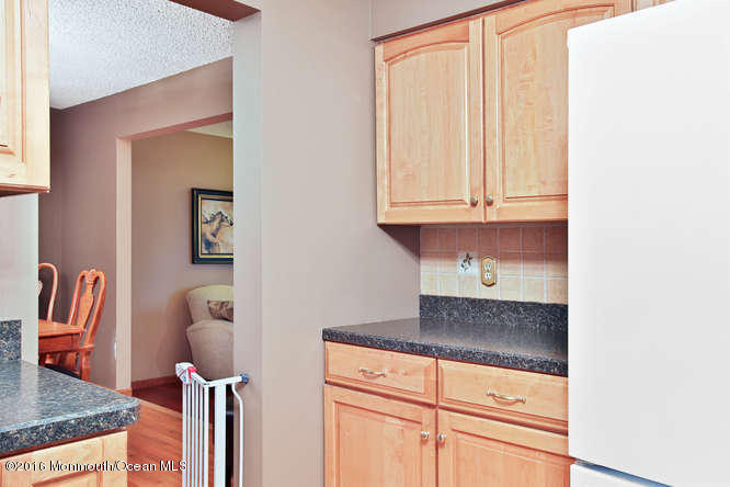 476 Diamond Road Jackson, NJ 08527 - Photo 13 of 37 a kitchen with granite countertop a white cabinets and a wooden floor
