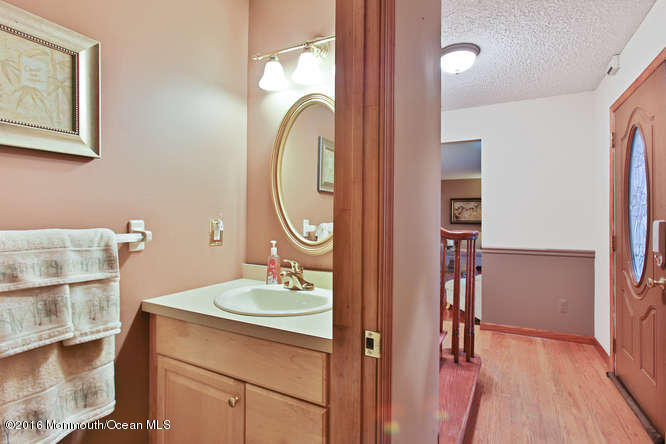 476 Diamond Road Jackson, NJ 08527 - Photo 19 of 37 a bathroom with a sink mirror and vanity