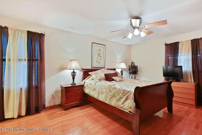 476 Diamond Road Jackson, NJ 08527 - Photo 27 of 37 a bed room with a bed and a chandelier