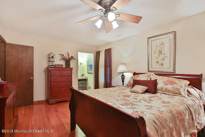 476 Diamond Road Jackson, NJ 08527 - Photo 29 of 37 a bedroom with a large bed and a chandelier
