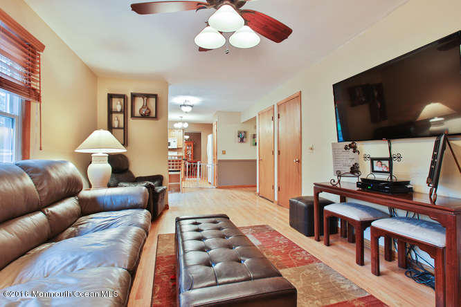 476 Diamond Road Jackson, NJ 08527 - Photo 3 of 37 a living room with furniture a chandelier and a flat screen tv