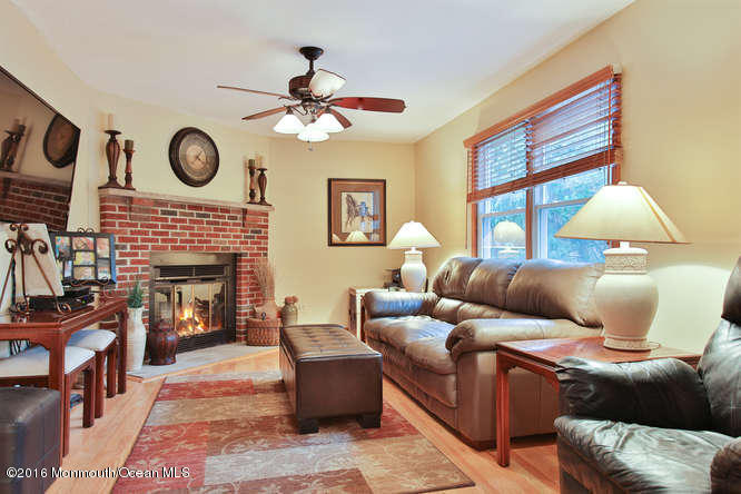 476 Diamond Road Jackson, NJ 08527 - Photo 8 of 37 a living room with furniture a fireplace window and a flat screen tv